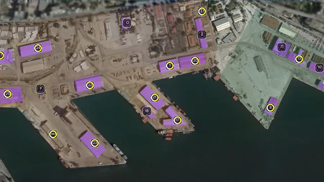 Satellite view of port piers with the controlled buildings highlighted and numbered.